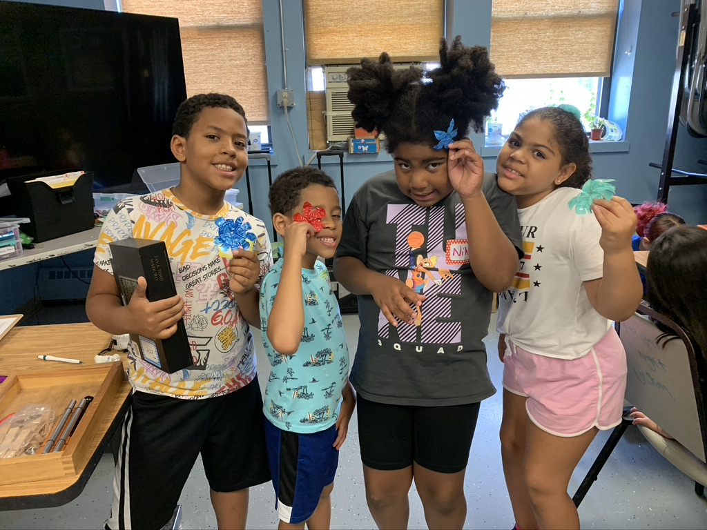 a group of children participating in trash to treasure event hosted by the empowerment factory