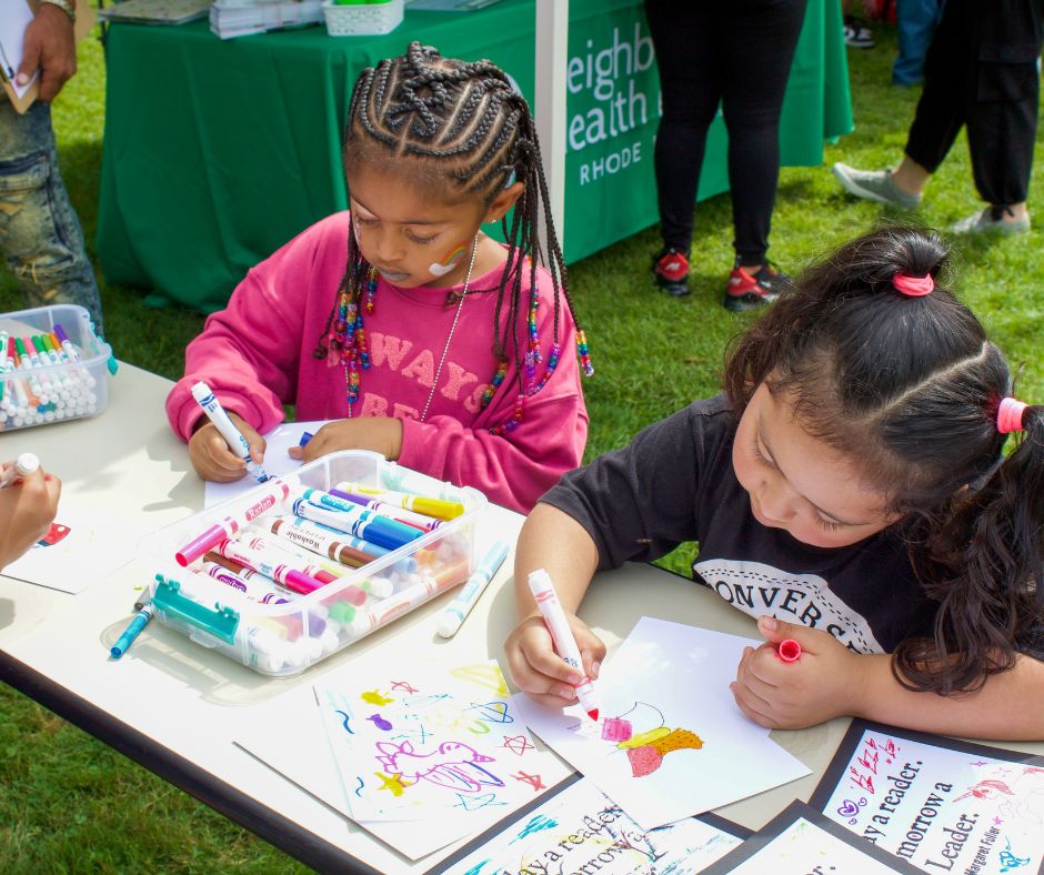 Two children coloring with markers outside at the 8th Annual Healthy Living Community Event 2024